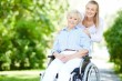 caregiver-pushing-senior-woman-in-wheelchair